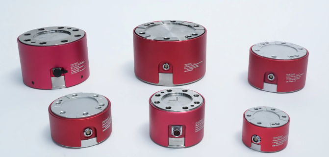 Six red cylindrical six-axis force sensors in multiple sizes